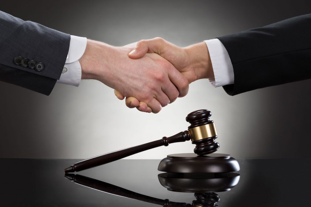 Shaking hands over a gavel