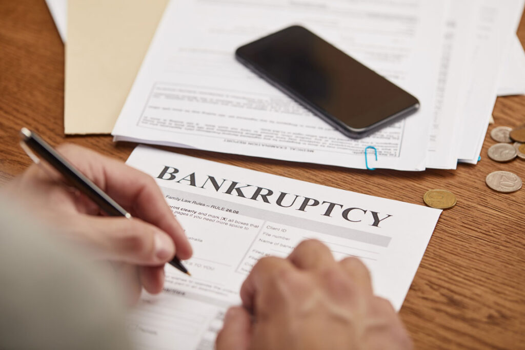 man filling in bankruptcy forms