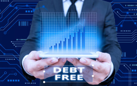 businessman holding up a chart that says debt free