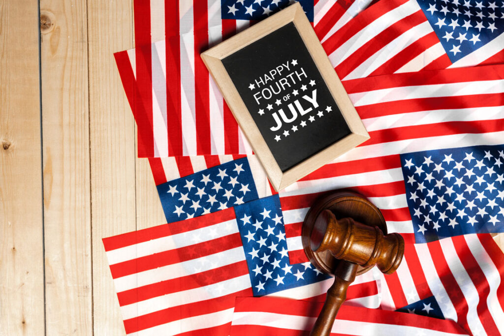 happy 4th of July with a gavel and American flags