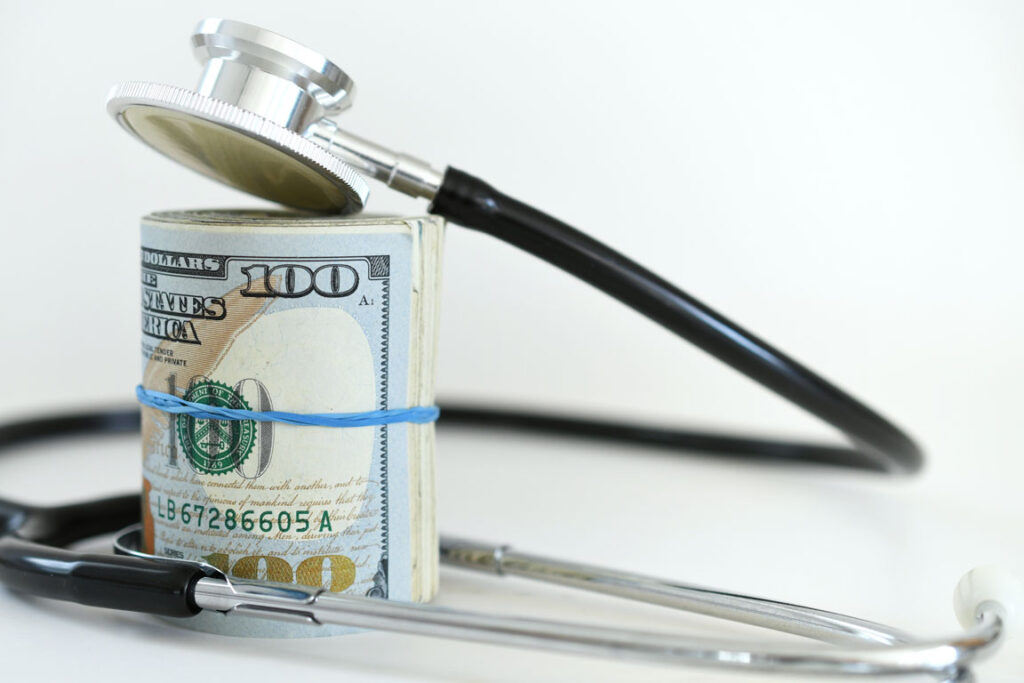 roll of money and a stethoscope