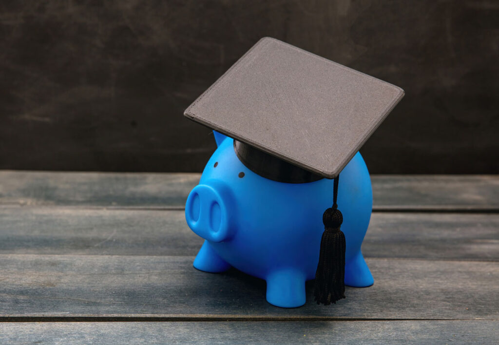 blue piggy bank with a college graduation cap
