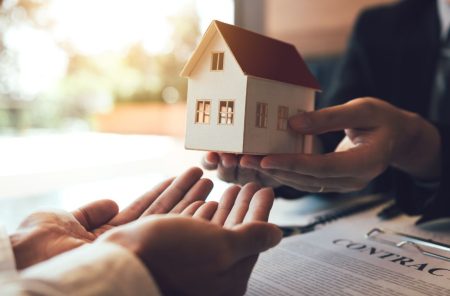 person giving a house to another person