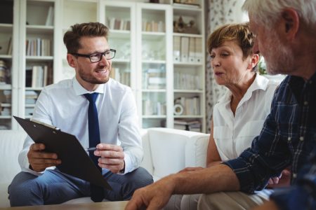Senior couple discussing finances with planner