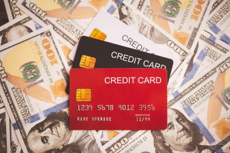 close-up-multiple-credit-cards-placed-on-the-dolla-2025-02-12-05-03-18-utc credit cards and money