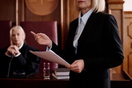 female-prosecutor-with-document-standing-in-front-2025-02-11-15-31-24-utc Female prosecutor