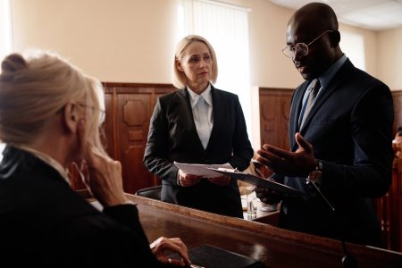 Attorneys discussing commercial litigation case in courtroom