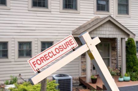 foreclosure sign in front of a house