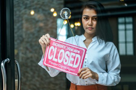 Woman with closed sign