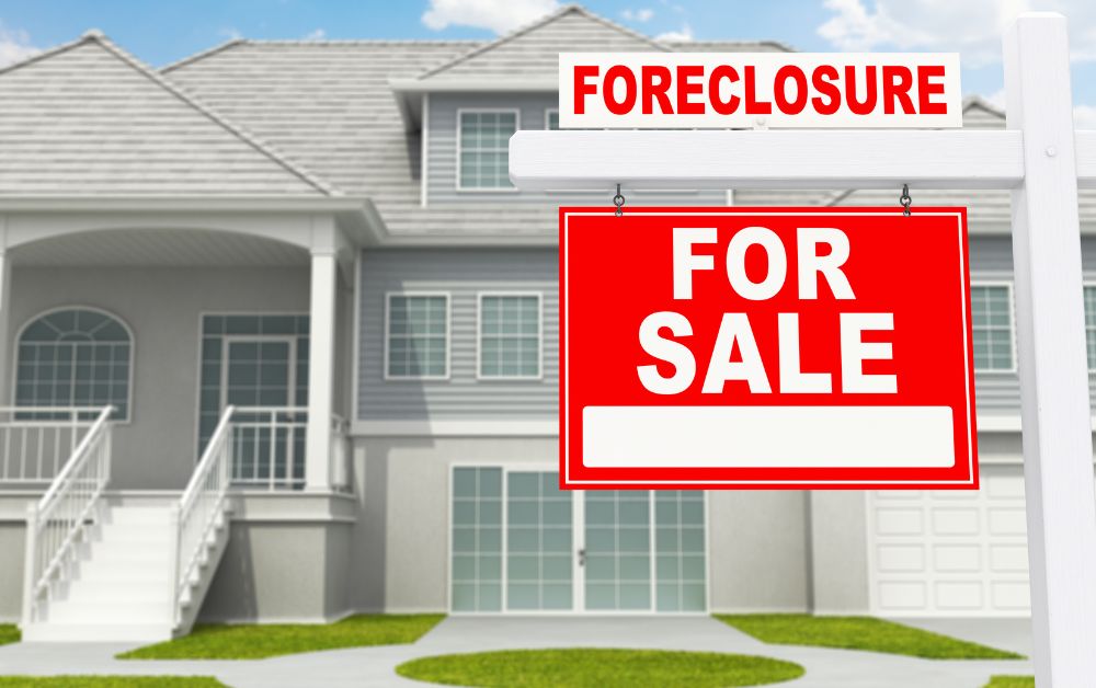 foreclosure sign in front of a gray suburban home