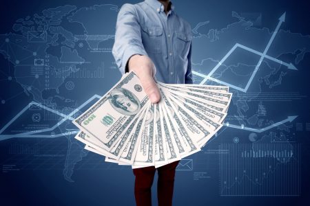 Young businessman holding a large amount of bills