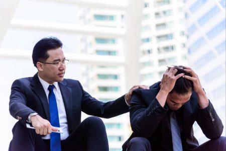 Lawyer sitting on stairs consoling businessman